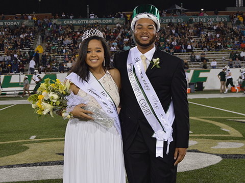 Prom King and Queen smiling at their coronation.