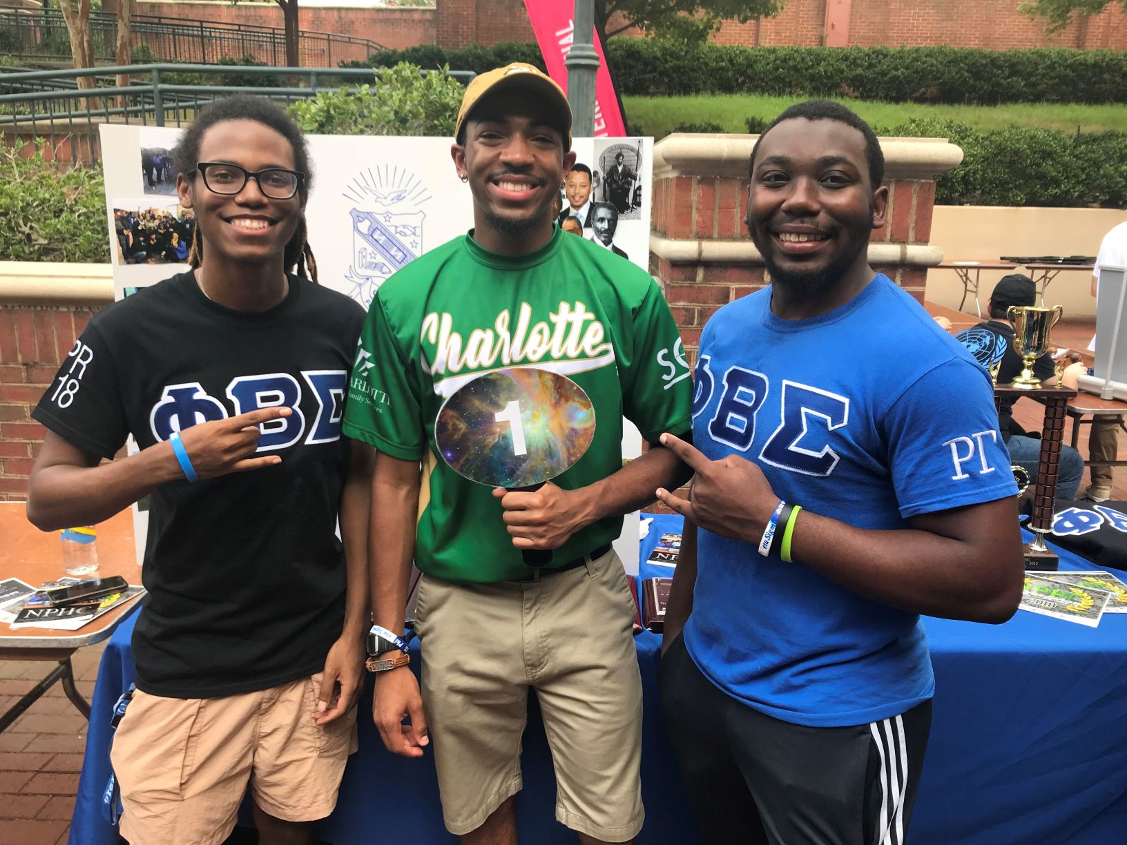 3 men representing a student organization at the Student Orgs Showcase