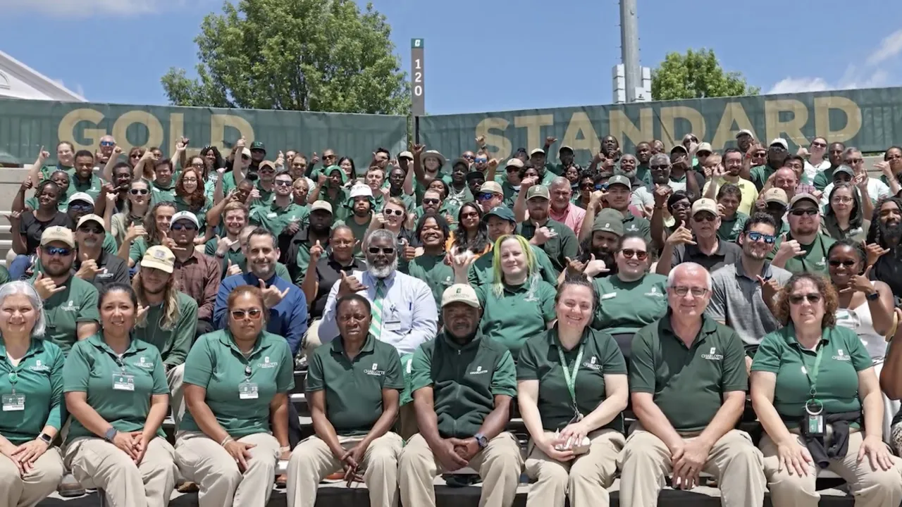 Facilities Operations team smiling in the stands of Jerry Richardson Stadium