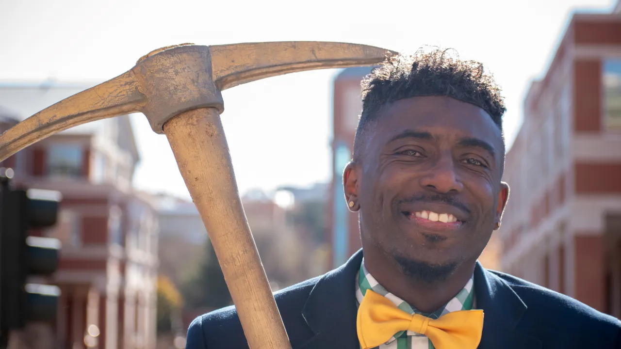 S.L. Ivey smiling while holding the Golden Pickaxe