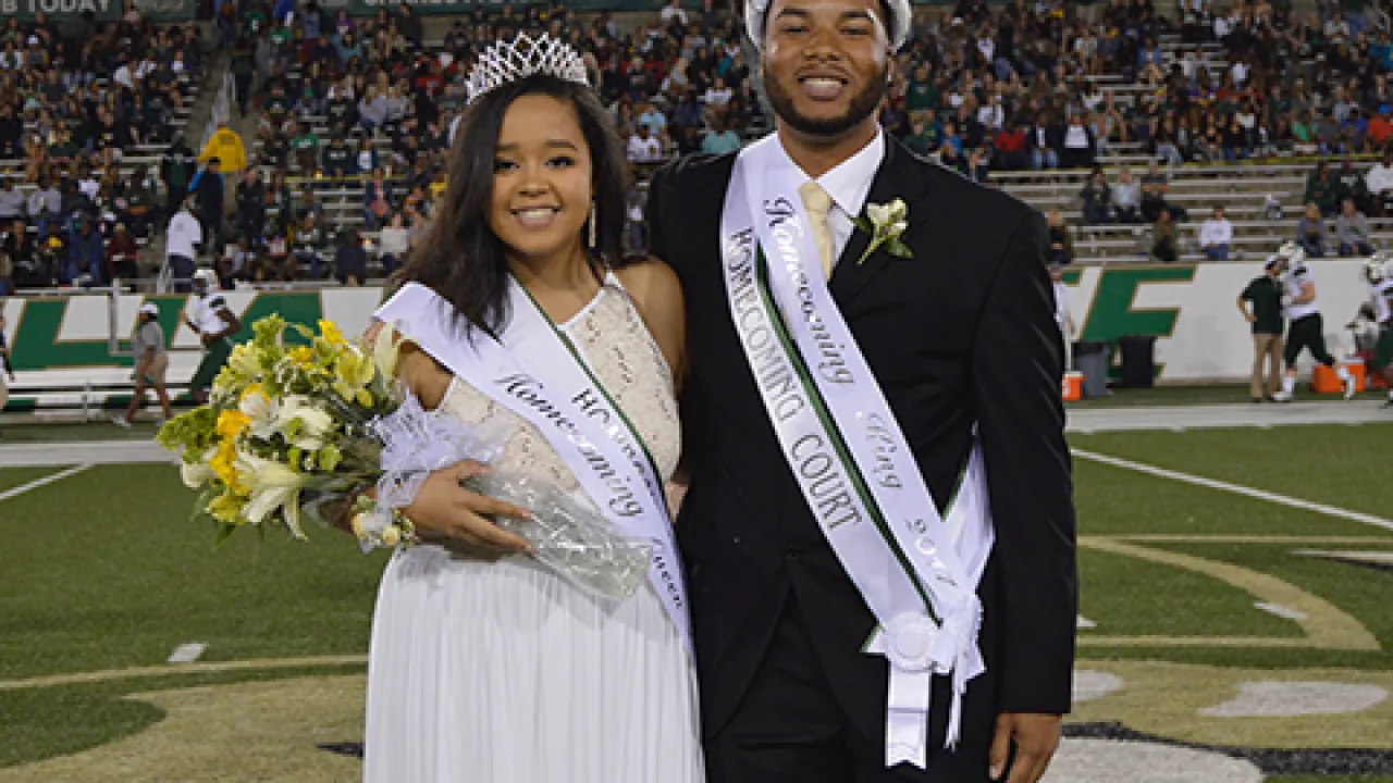 Prom King and Queen smiling at their coronation.