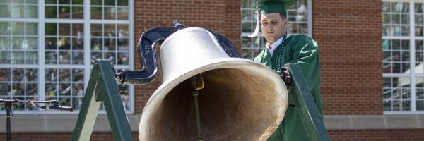 Student ringing bell at commencement