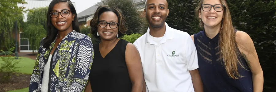 Aayla Alexander, Leigh Norwood, Terrence Harper and Daniela Recabarren smiling outside