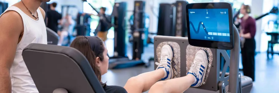 Two students using UREC's EGYM equipment
