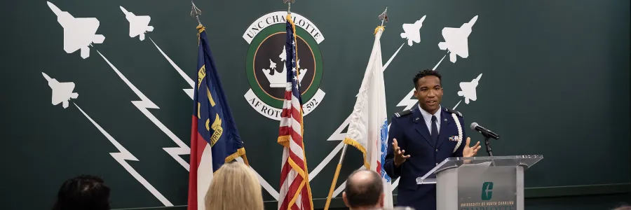 Speaker at podium with audience members for Veteran Day 2022 Ceremony