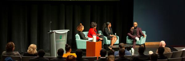 MLK panel discussion with three alumni guests on stage