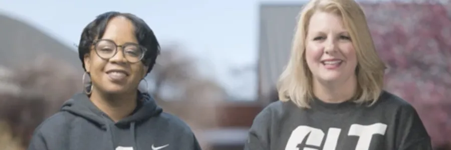 Dr. Mari Ross and Christine Reed Davis smiling with grey UNC Charlotte hoodies on