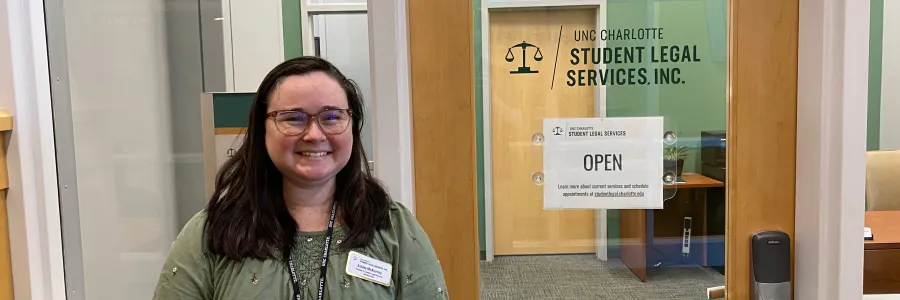 Ashley McAlarney standing in front of the Student Legal Services office in the Popp Martin Student Union.