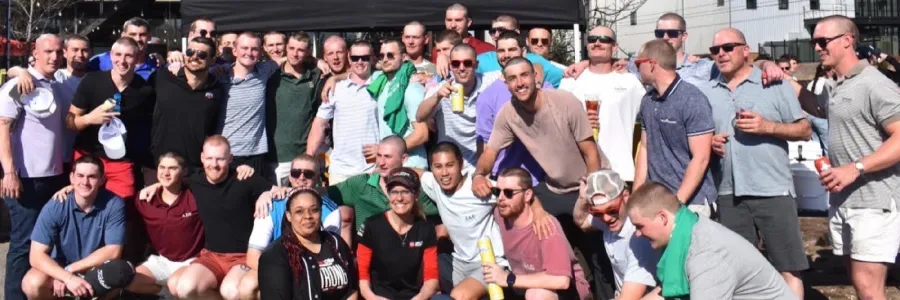Large group of fraternity members with shaved heads to promote contributing toward cancer research.
