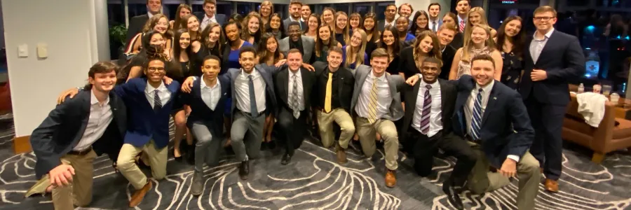 A group picture of fraternity and sorority members smiling.