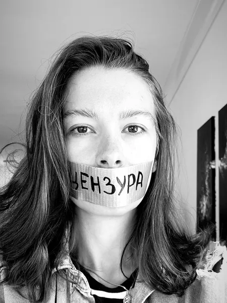 Aleksandra Degernes black and white with tape over her mouth that has the Russian word for "censorship" written on it.