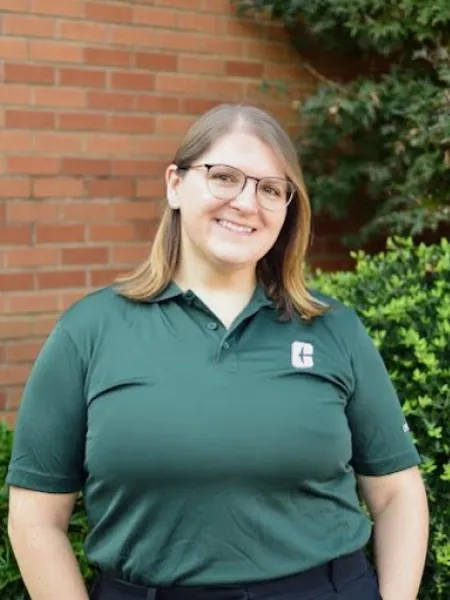 Amanda Oller-Kelly smiling in a UNC Charlotte polo
