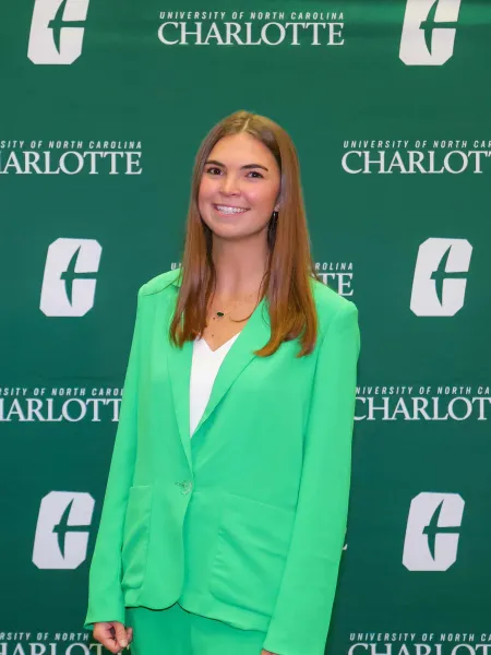Dawson Jarman smiling in front of a UNC Charlotte backdrop