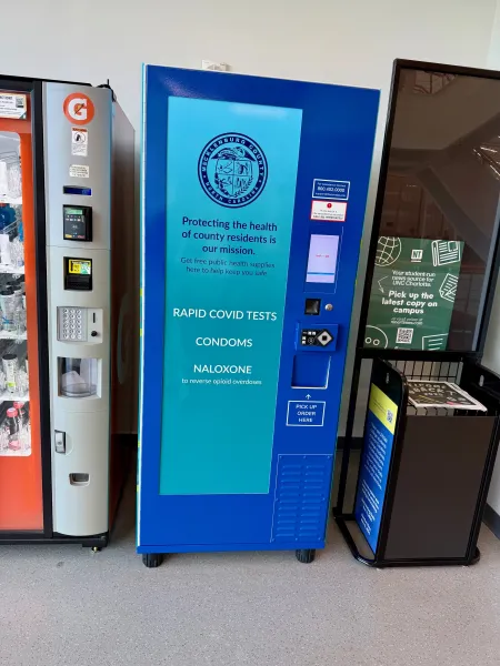 The public health kiosk in the third floor of UREC, it is blue with a lighter blue section that displays what is in the machine