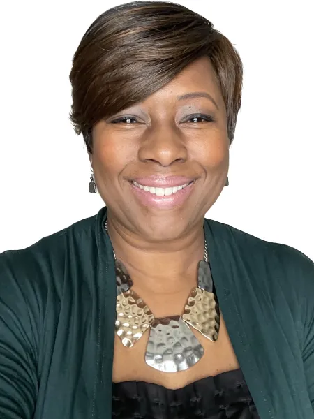 Shelia Higgs Burkhalter smiling with a blank background