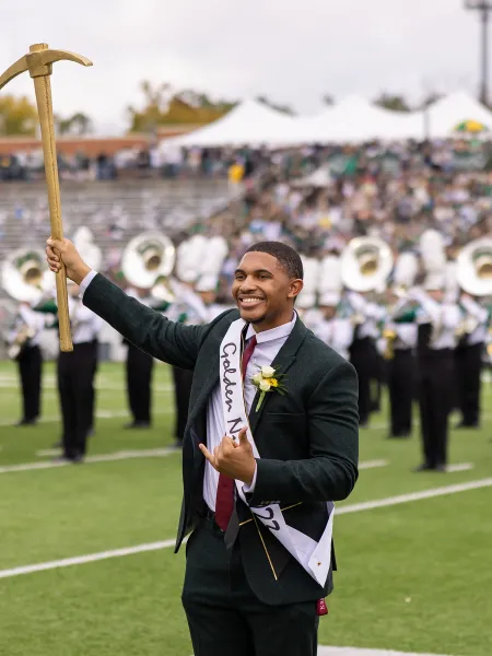 Kenan Moore smiling with the golden pickaxe after winning the Golden Niner.