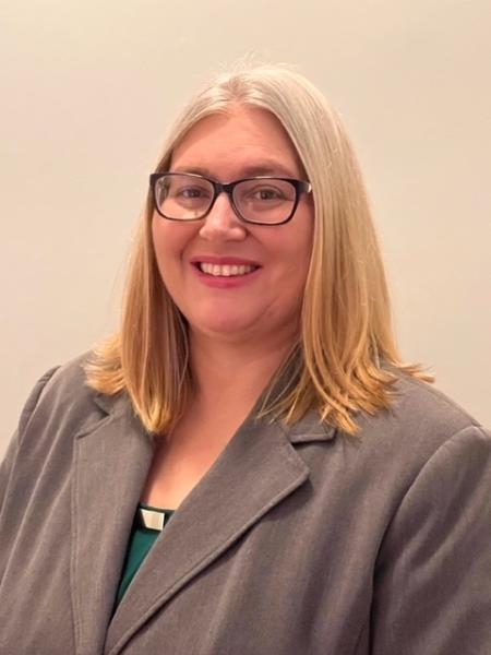 Nicole Piscitelli smiling in business attire.