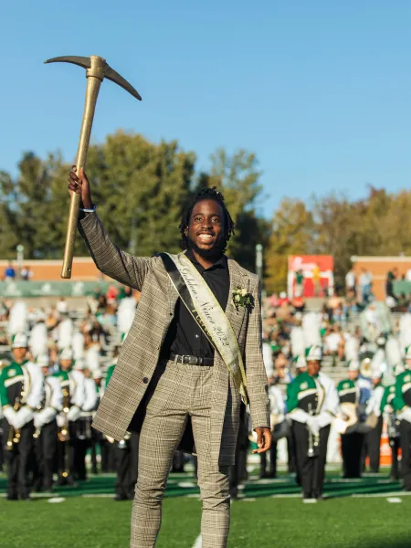 Ra'Quan Leary smiling while holding the golden pickaxe