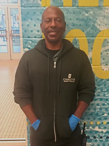 Sean Grandison smiling in UREC with a hoodie on