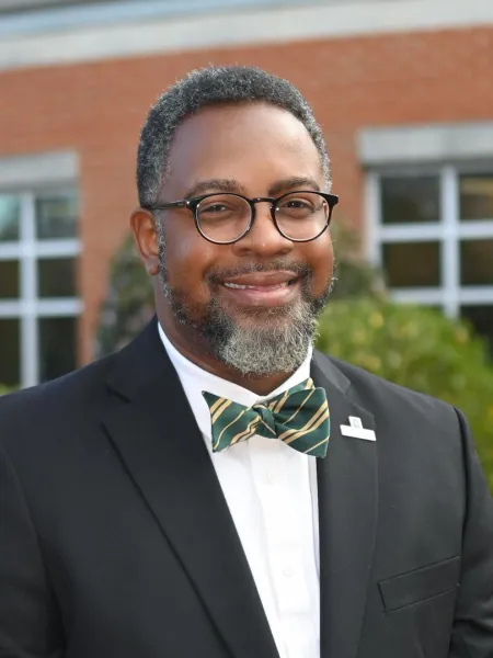 Chris Smith smiling with a bowtie