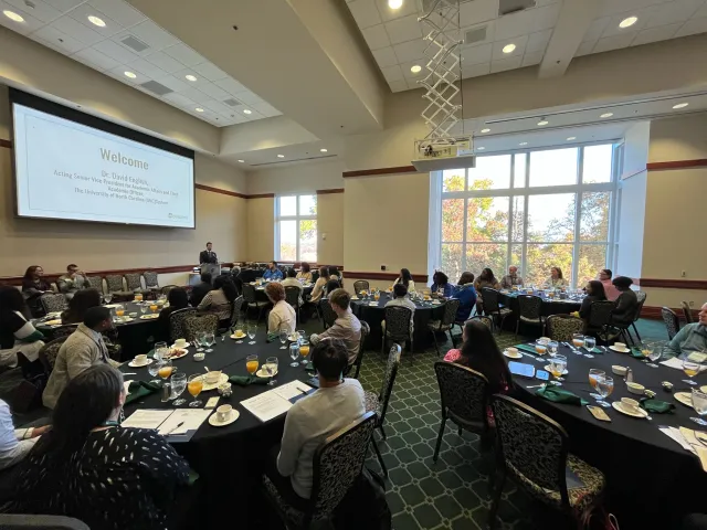 Administrators across the UNC System sit and listen to a lecture during the Financial Literacy Symposium.