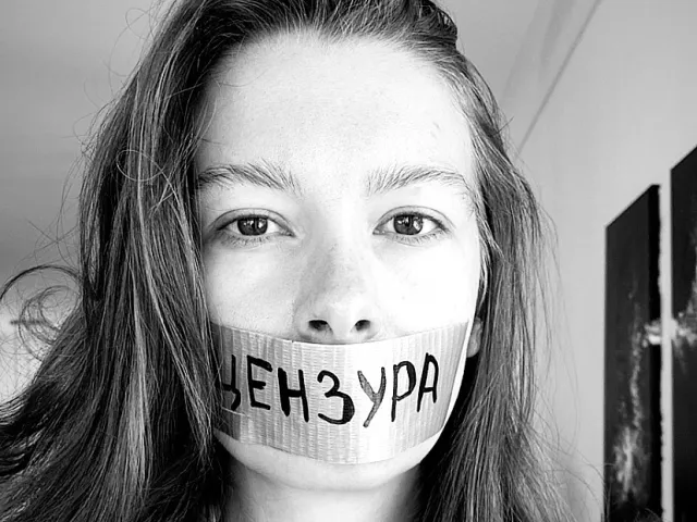 Aleksandra Degernes black and white with tape over her mouth that has the Russian word for "censorship" written on it.