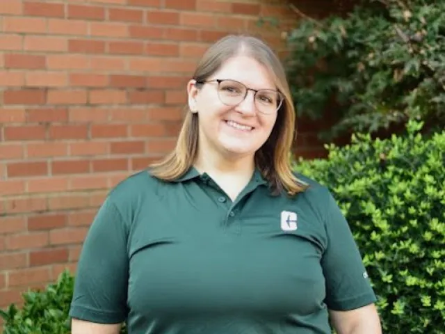 Amanda Oller-Kelly smiling in a UNC Charlotte polo