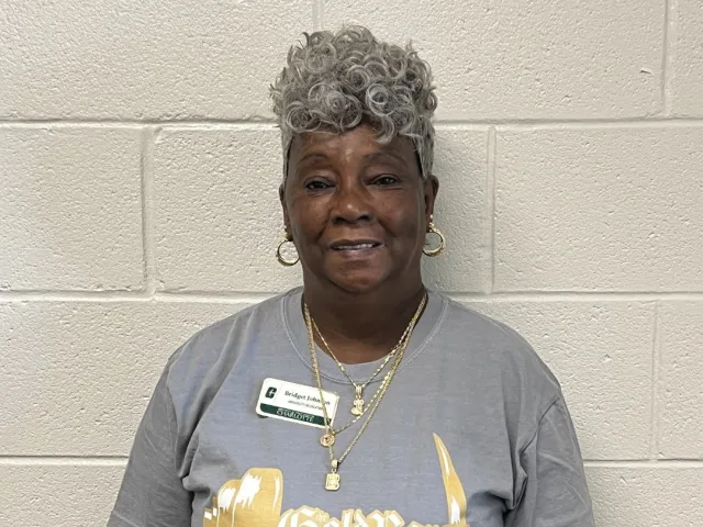 Bridget Johnson smiling in a UREC Gold Bar shirt