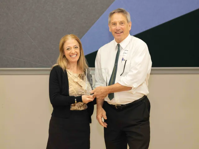 Kelly Merges accepts CHESS award for part-time faculty member of the year