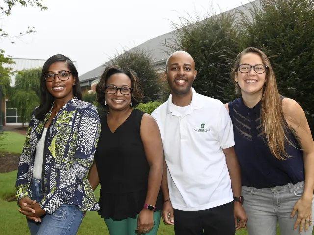 Aayla Alexander, Leigh Norwood, Terrence Harper and Daniela Recabarren smiling outside