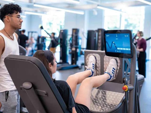 Two students using UREC's EGYM equipment