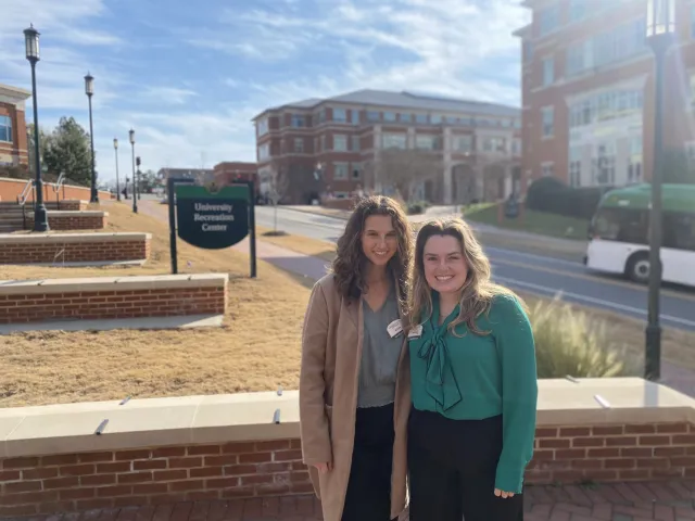 Grace Nixon and Alexa Schoubert standing outside of the University Rec Center