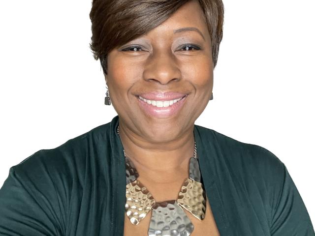 Shelia Higgs Burkhalter smiling with a blank background