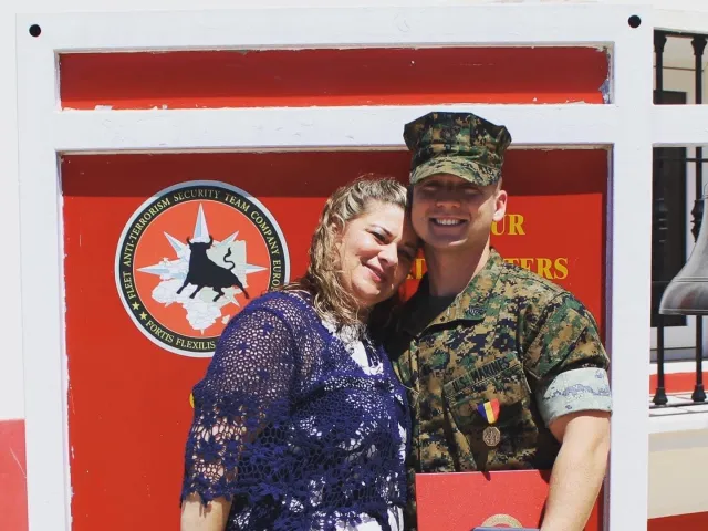 Chris and Peter Demetriades smiling with Peter in his military uniform