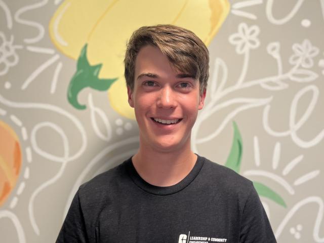 Matthew McGrew smiling in a black T-shirt