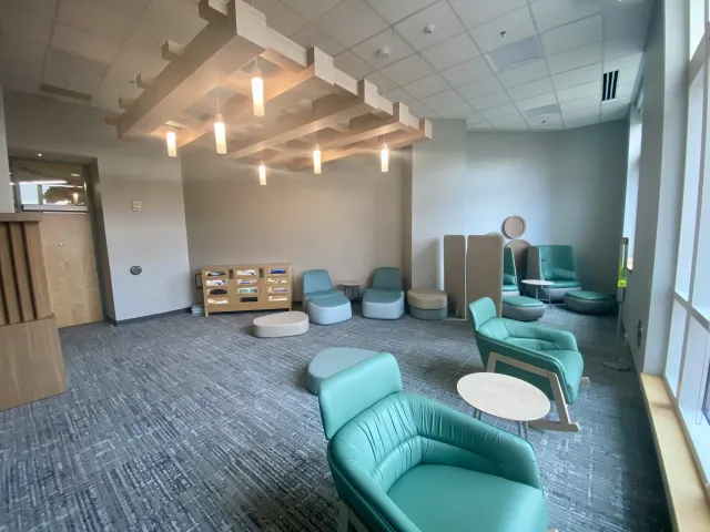 View of the Niner Nest's seating, lockers of items and warm lighting