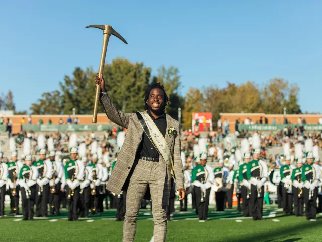 Ra'Quan Leary smiling while holding the golden pickaxe