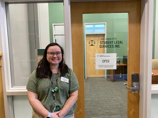 Ashley McAlarney standing in front of the Student Legal Services office in the Popp Martin Student Union.