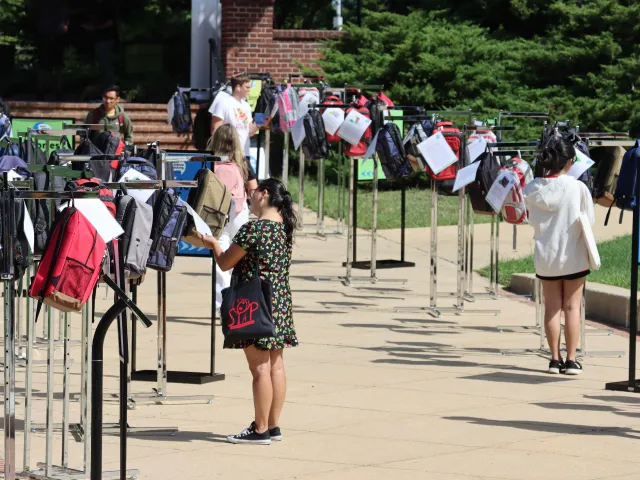 Students looking at backpacks from the Send Silence Packing event