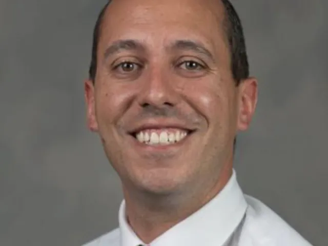 Larry Mellinger smiling with a green and yellow tie