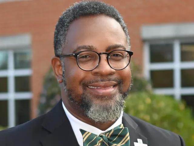 Chris Smith smiling with a bowtie