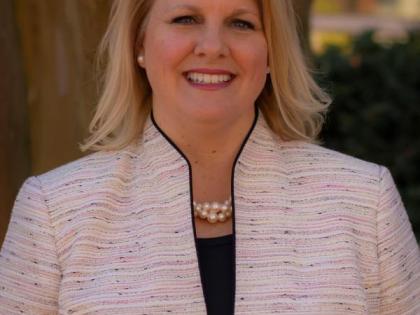 Christine Reed Davis smiling outside