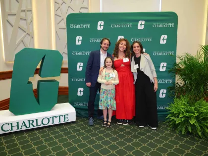 A student and their family posing for a photo at the University Honors and Awards