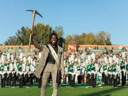 Ra'Quan Leary smiling while holding the golden pickaxe