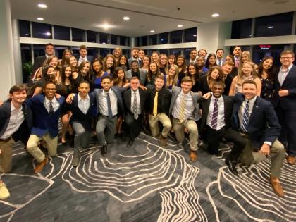 A group picture of fraternity and sorority members smiling.