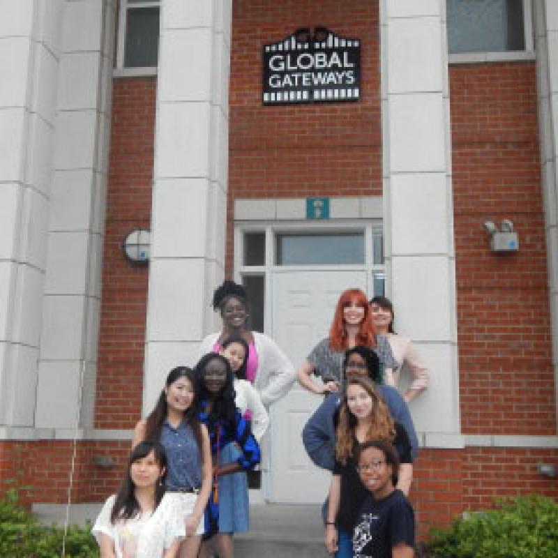 A group of women standing on the stairs to the Global Gateways residence hall.