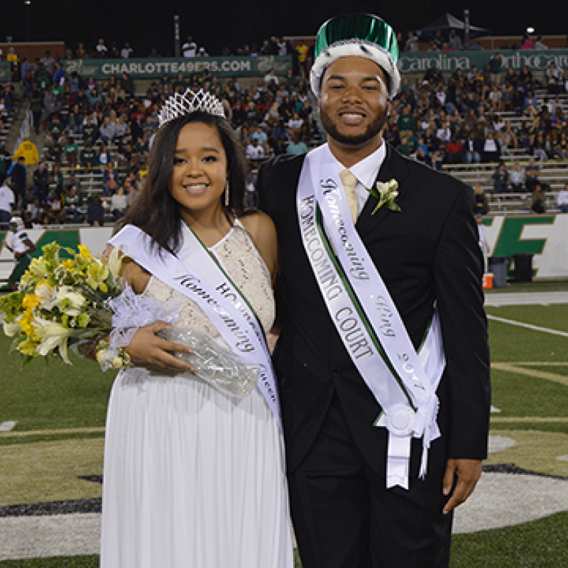 Prom King and Queen smiling at their coronation.