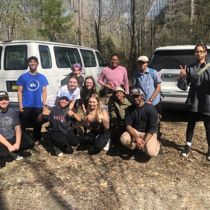 Student volunteers outside in woods