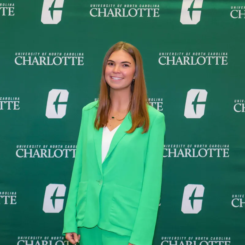Dawson Jarman smiling in front of a UNC Charlotte backdrop