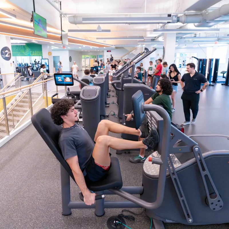 A wide shot of UREC where the EGYM equipment is located, and students using the equipment